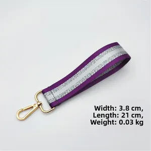 Detail of purple and silver glitter woven strap with a gold lobster clasp 21cm long