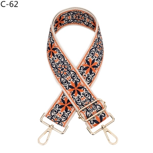 Detail of adjustable floral embroidery wide shoulder strap with golden lobster clasps