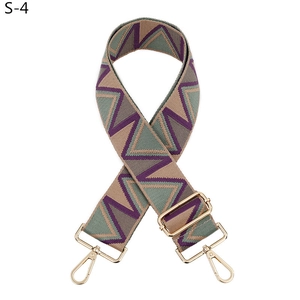 Detail of adjustable geometric jacquard strap with gold-tone metal swivel lobster clasps