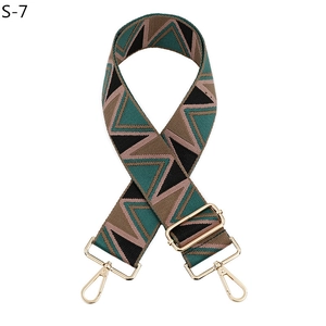 Detail of adjustable geometric patterned woven strap with gold metal lobster clasps