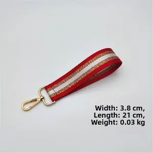 Detail of red, white and gold striped wrist strap with dimensions 3.8x21cm and metal hook