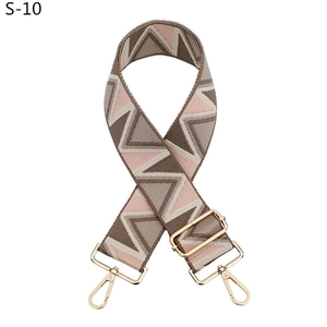 Detail of adjustable geometric wave woven shoulder strap with gold lobster clasps