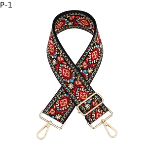 Detail of bohemian dandelion embroidered bag strap with golden lobster clasps and metal buckle