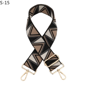 Detail of adjustable wide shoulder strap with geometric diamond jacquard and gold hardware