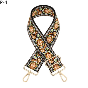 Detail of ethnic embroidery guitar strap with colorful patterns and golden metal hooks