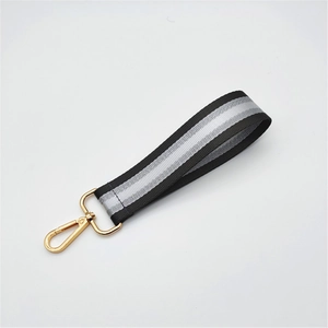 Close-up of tricolor striped braided hand strap with golden metal lobster clasp