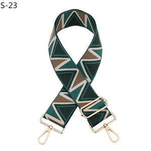 Detail of adjustable geometric woven strap with gold metal hooks and wavy patterns