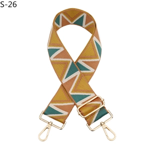 Close-up of geometric pattern replacement bag strap with light gold metal clips
