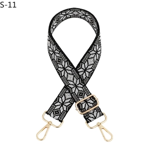 Adjustable woven canvas shoulder strap with black and white geometric pattern and gold hooks