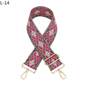 Detail of pink and grey geometric diamond woven bag strap with golden metal swivel hooks
