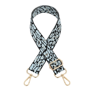 Detail of adjustable leopard print bag strap with blue weave and golden sequins