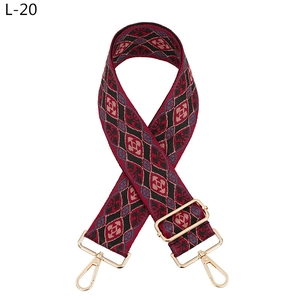 Close-up of geometric diamond pattern strap with gold metal lobster clasps