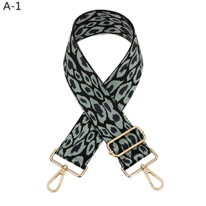 Detailed view of the wide leopard print bag strap with golden metal lobster clasps