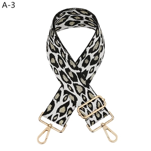 Detail of adjustable leopard print bag strap with golden rotating metal hooks
