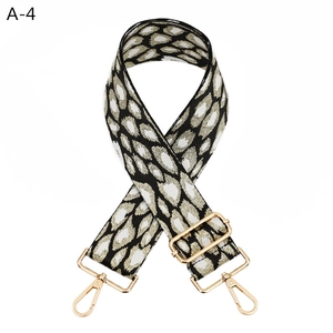 Close-up of adjustable leopard pattern bag strap with polished gold-tone metal hooks