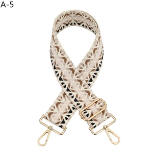Close-up of geometric jacquard bag strap A-5 with gold buckles and ethnic pattern