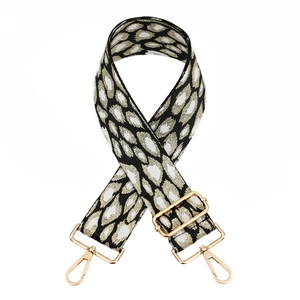 Adjustable leopard print bag strap with golden metal hardware and woven texture