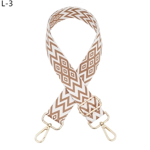 Adjustable woven strap for handbags featuring brown and white geometric diamond patterns