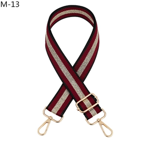 Close-up of adjustable red gold and black striped strap with golden metal clasps