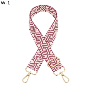 Detail of adjustable jacquard strap with burgundy geometric pattern and gold buckles