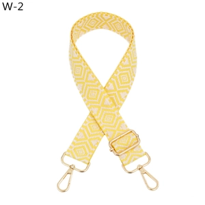 Detail of adjustable yellow jacquard bag strap with golden alloy lobster clasps