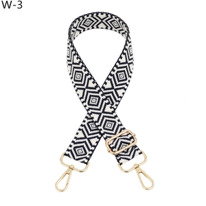 Detail of adjustable woven replacement bag strap with black geometric diamond patterns