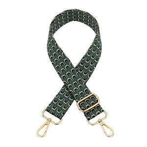 Adjustable geometric woven bag strap with green pattern and gold swivel hooks