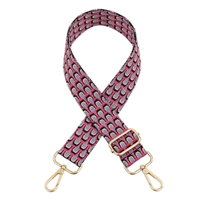 Adjustable woven shoulder strap with pink peacock feather pattern and gold metal hooks