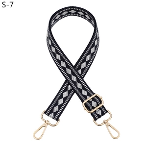Detail of adjustable woven bag strap featuring a classic black and white diamond pattern