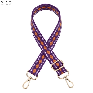 Detail of adjustable purple and orange diamond pattern woven shoulder strap with gold hooks