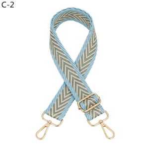 Adjustable blue and beige herringbone weave shoulder strap with gold-tone hardware detail