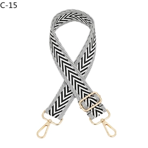 Detailed view of the gray and white chevron woven strap with polished gold lobster clasps