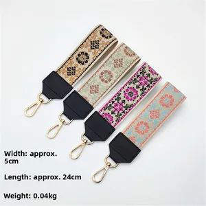 Ethnic embroidered bag strap detail with gold spring hooks and dimensions 24x5cm