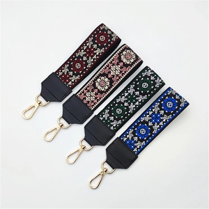 Ethnic style embroidered purse straps with floral patterns and gold metal clasps