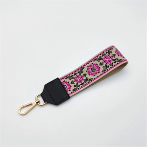 Ethnic style embroidered wrist strap with floral patterns and golden metal clasp for handbags