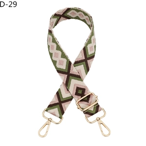 Detail of adjustable geometric diamond pattern bag strap with gold metal lobster clasps