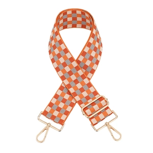 Adjustable wide plaid bag strap with orange checkerboard pattern and gold metal hooks