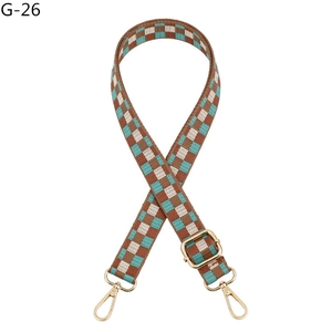 Adjustable checkerboard pattern bag strap with gold metal buckles and brown accents