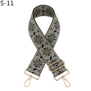 Close-up of woven ethnic strap with geometric pattern and golden lobster clasps
