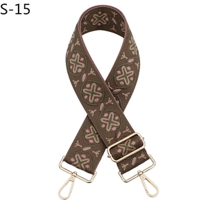 Close-up of ethnic pattern jacquard strap with gold-tone swivel hooks and slider