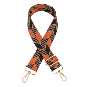 Adjustable wide woven guitar strap with orange and black geometric leaf patterns