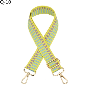 Detail of adjustable colorful woven jacquard shoulder strap with gold metal lobster clasps