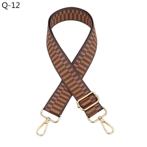 Adjustable geometric pattern bag strap with gold hardware and brown orange jacquard weave