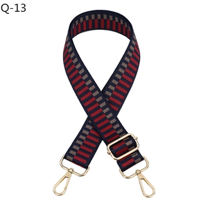 Adjustable navy, red, and grey geometric woven shoulder strap with gold metal hardware