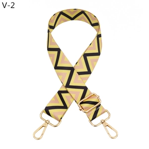 Detail of adjustable bag strap with colorful wave pattern and golden metal hooks
