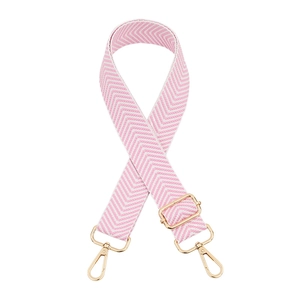 Detail of adjustable pink and white herringbone bag strap with gold metal lobster clasps