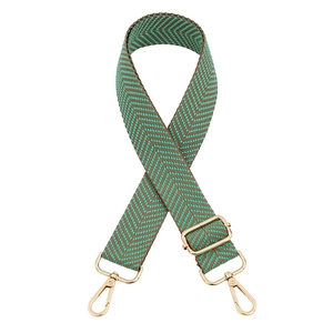Detail of adjustable thickened woven bag strap with green pattern and gold hooks