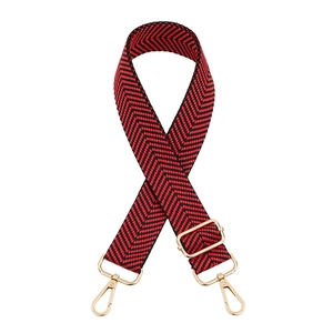 Detail of red and black chevron woven strap with adjustable gold lobster clasps