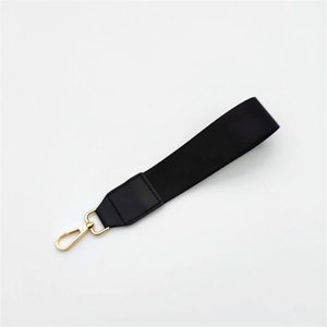 Detail of black woven nylon wrist strap with leather reinforcement and golden lobster clasp