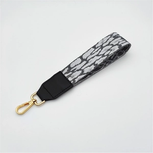 Zebra print fabric wrist strap with leather connection and golden metal swivel hook